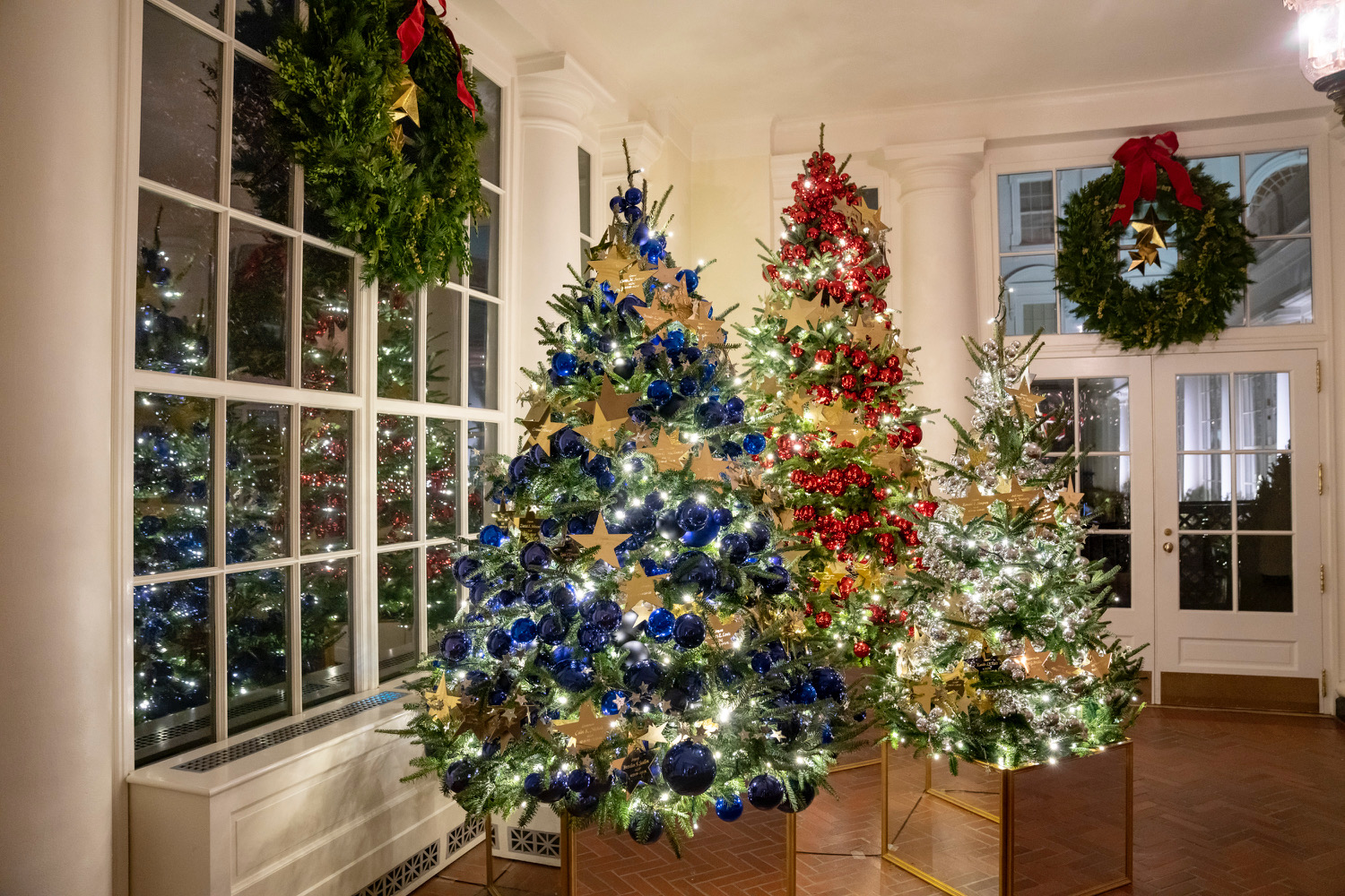 Christmas trees and garland in the Grand Foyer as the 2022 White House  Christmas decorations are